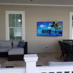 Samsung tv mounted on a wall in the patio