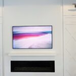 Samsung Frame TV on top of fireplace and controlled by Control4 remote